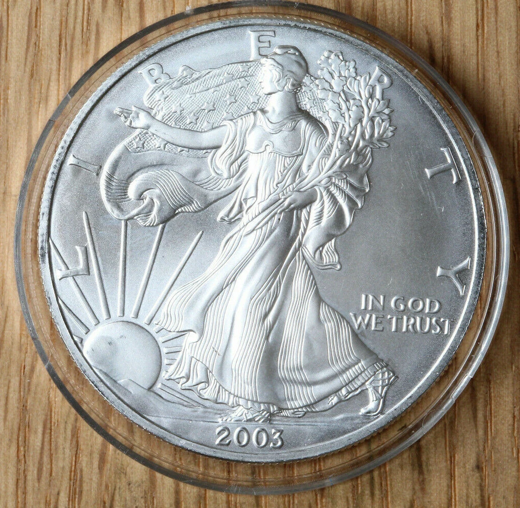 2003 Silver Eagle die cap error showing dramatically cupped coin surface where the planchet adhered to the die